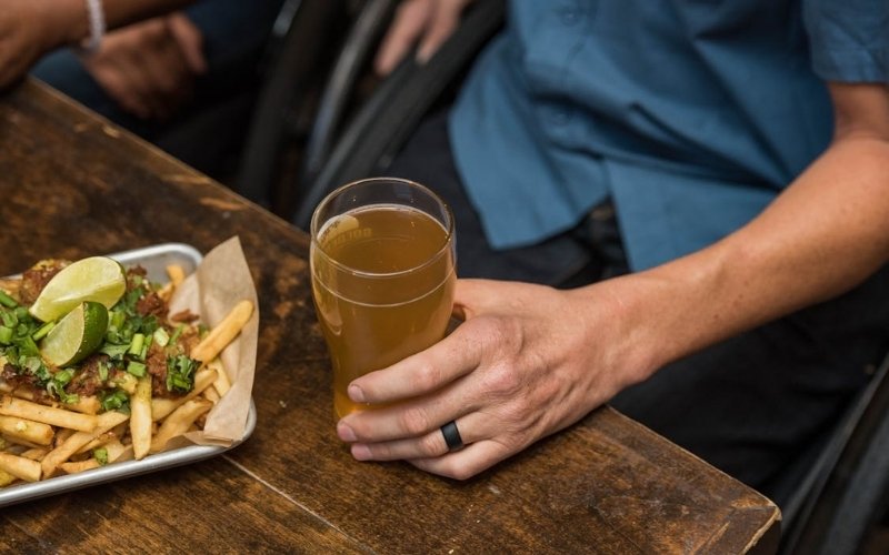 Disabled diner enjoying a restaurant meal as do restaurants accept ebt in their state