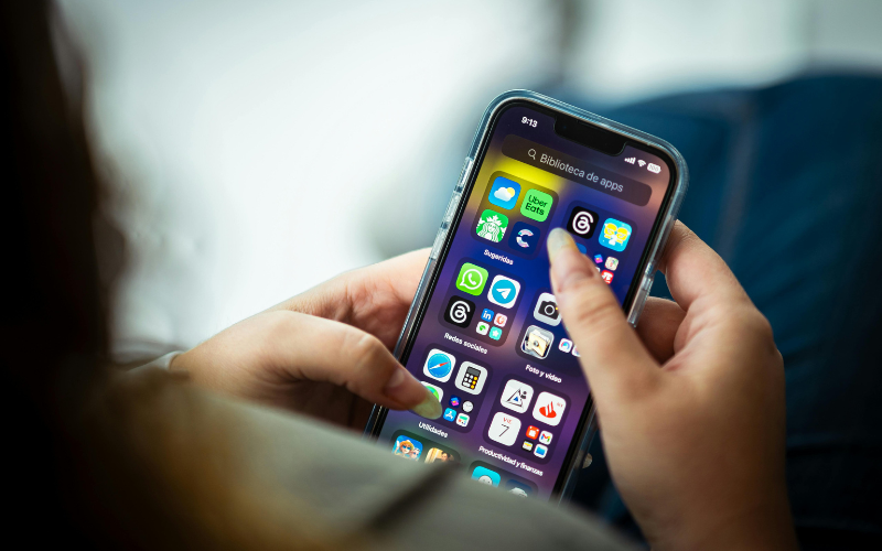 A person using a smartphone that represents access to a free government phone in Texas