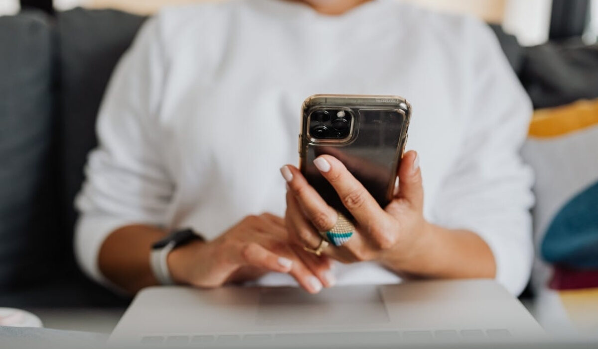 Woman checking eligibility details for a free iPhone 11 Pro Max on her smartphone in 2026