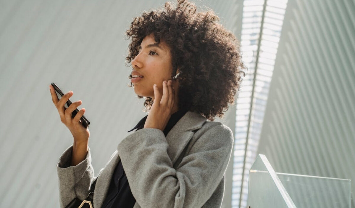 Woman using a free iphone 13 pro max government phone after Lifeline approval