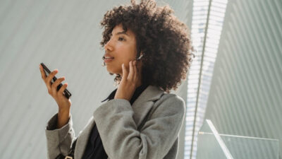 Woman using a free iphone 13 pro max government phone after Lifeline approval