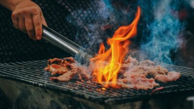 Grilling pork as the best meat to smoke in smoker for rich smoky flavor