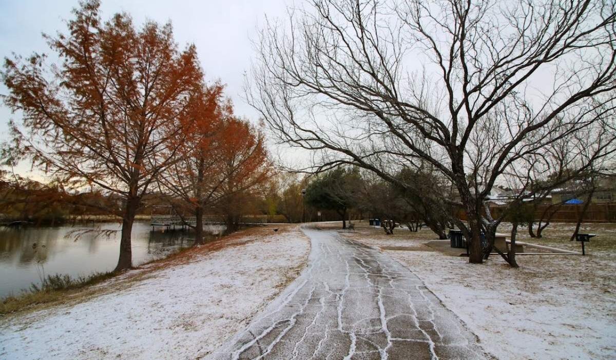Cold front Texas creates icy ground on a quiet lakeside path