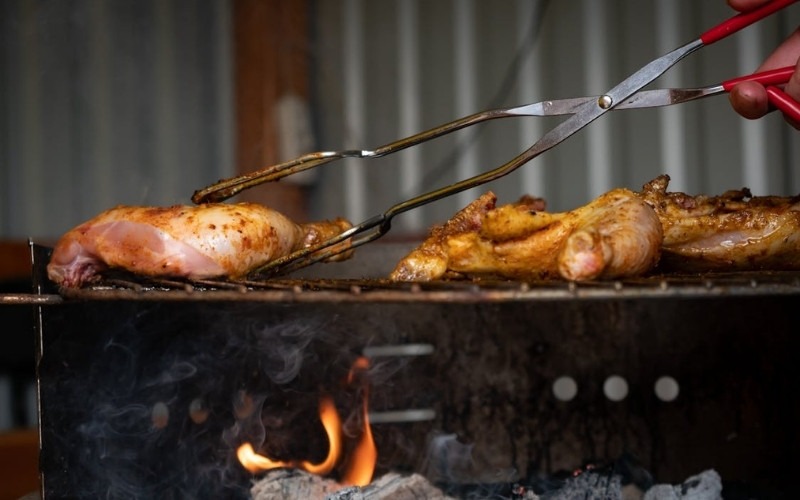 Chicken grilling as one of the best meat to smoke for juicy and flavorful poultry