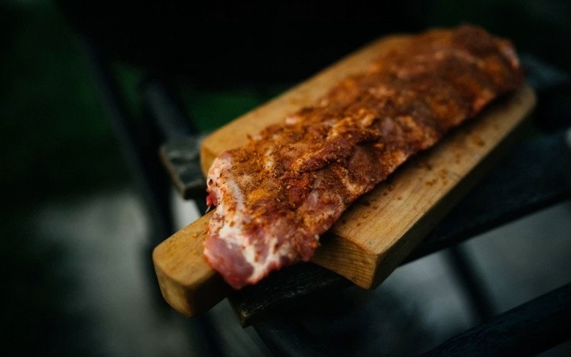 Evenly coat the ribs with BBQ rub before following how to smoke ribs on a pellet grill